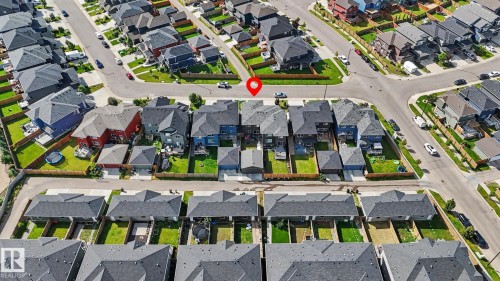 Aerial perspective showcasing a residential neighborhood with diverse housing styles, paved streets, and green spaces - 2314 Wonnacott Crescent Sw, Edmonton, AB -  With View