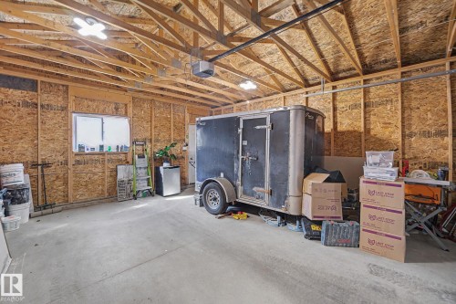 Spacious garage featuring concrete flooring and exposed wood framing - 2314 Wonnacott Crescent Sw, Edmonton, AB - Indoor Photo Showing Other Room