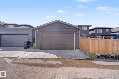 Detached garage with a paneled door and concrete driveway - 2314 Wonnacott Crescent Sw, Edmonton, AB - Outdoor
