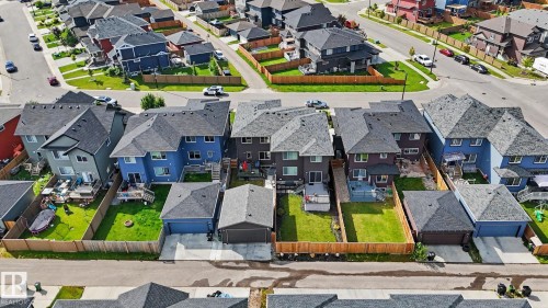 Aerial perspective showcasing a residential neighborhood with detached homes, each featuring private backyards with wooden fencing - 2314 Wonnacott Crescent Sw, Edmonton, AB - Outdoor With View