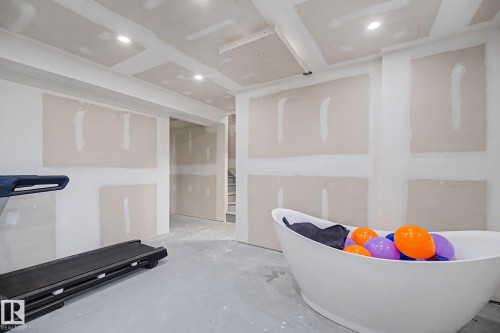 Unfinished interior space featuring recessed lighting and a freestanding tub - 2314 Wonnacott Crescent Sw, Edmonton, AB - Indoor Photo Showing Other Room