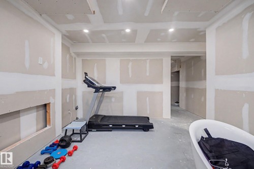 Unfinished interior space featuring recessed lighting, a built-in wall niche, and an open doorway leading to an additional area - 2314 Wonnacott Crescent Sw, Edmonton, AB - Indoor