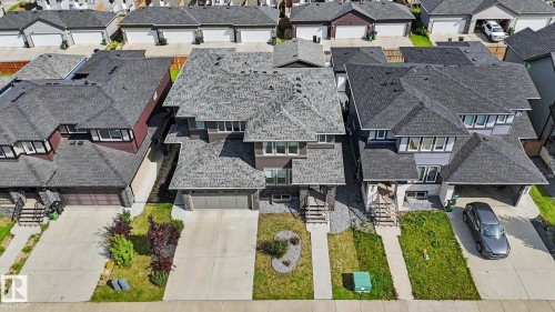 Contemporary two-story residence featuring a dark shingle roof, integrated double garage, and a concrete driveway - 2314 Wonnacott Crescent Sw, Edmonton, AB - Outdoor
