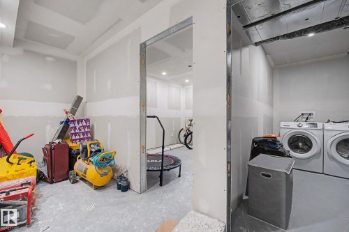 Utility space featuring unfinished drywall, exposed metal framing, and a concrete floor - 2314 Wonnacott Crescent Sw, Edmonton, AB - Indoor Photo Showing Laundry Room
