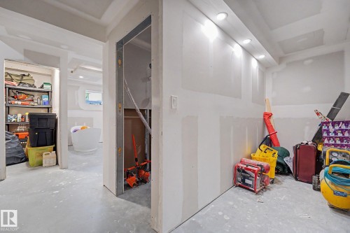 Unfinished interior space featuring drywall installation, recessed lighting, and a concrete floor - 2314 Wonnacott Crescent Sw, Edmonton, AB - Indoor Photo Showing Basement