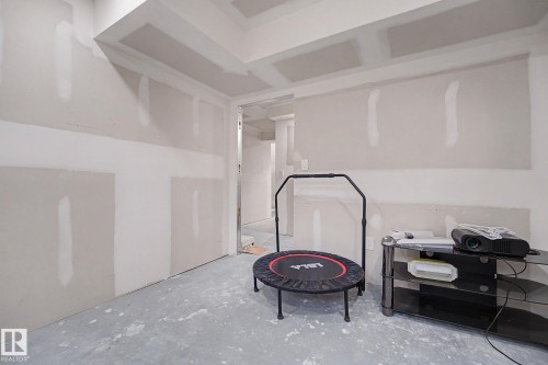 Unfinished interior space featuring drywall installation, a concrete floor, and recessed lighting - 2314 Wonnacott Crescent Sw, Edmonton, AB - Indoor Photo Showing Other Room