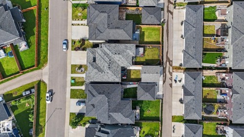 Aerial perspective showcasing residential properties with uniform rooflines and individual fenced backyards - 2314 Wonnacott Crescent Sw, Edmonton, AB - Outdoor