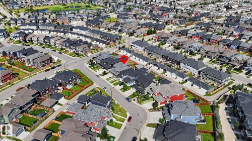 Aerial view showcasing a residential neighborhood with diverse housing styles, including detached homes and multi-family dwellings - 2314 Wonnacott Crescent Sw, Edmonton, AB - 
