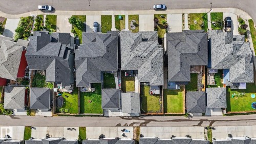 Aerial view showcasing multiple residential properties with pitched roofs, individual backyards, and paved driveways - 2314 Wonnacott Crescent Sw, Edmonton, AB - 