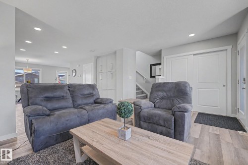 Open-concept living space featuring wood-finish flooring and recessed lighting - 2314 Wonnacott Crescent Sw, Edmonton, AB - Indoor Photo Showing Living Room