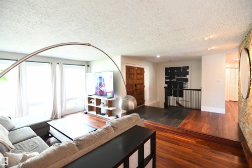 The large windows in the sunken living room are a nice touch, and the same large window format was used in the bedrooms, and even in the attached double garage - 572 Lessard Drive Nw, Edmonton, AB - Indoor Photo Showing Living Room