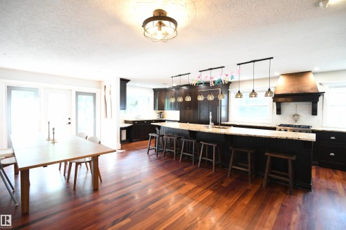 Clearly, the kitchen was purpose built for entertaining, and there is obviously room for an oversized dining table.  Great access to the rear yard and patio from the garden doors as well - 572 Lessard Drive Nw, Edmonton, AB - Indoor