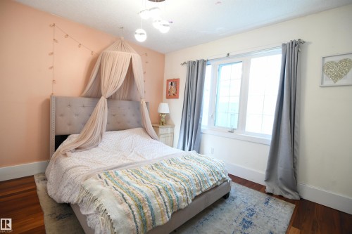 The second and third bedrooms on the main floor are both generously sized, have large closets, and wide, tall windows.  This is a great layout - 572 Lessard Drive Nw, Edmonton, AB - Indoor Photo Showing Bedroom