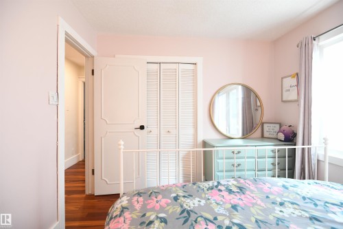 The second and third bedrooms on the main floor are both generously sized, have large closets, and wide, tall windows.  This is a great layout - 572 Lessard Drive Nw, Edmonton, AB - Indoor Photo Showing Bedroom