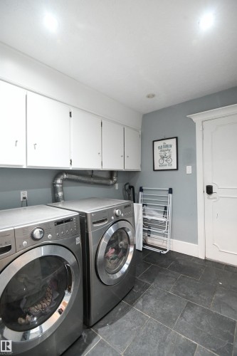 The main floor laundry area is steps away from the bedrooms, and is conveniently located near the access to the double attached garage - 572 Lessard Drive Nw, Edmonton, AB - Indoor Photo Showing Laundry Room