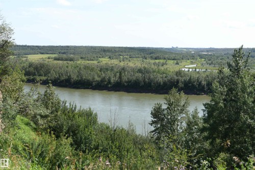 The home is located less than a block from the river valley, park, and trails.  It is also only a few short steps away from the Lessard Community League playground, on a quiet street, with easy access to amenities - 572 Lessard Drive Nw, Edmonton, AB - Outdoor With View