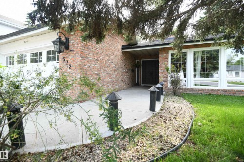 A covered grand front entrance with a double doorway welcomes you and your guests.  This is a great family home, and thanks to the open layout, and stunning kitchen, is a dream setup for entertaining - 572 Lessard Drive Nw, Edmonton, AB - Outdoor