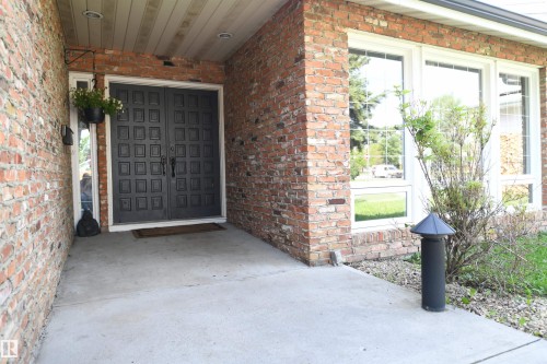 A covered grand front entrance with a double doorway welcomes you and your guests.  This is a great family home, and thanks to the open layout, and stunning kitchen, is a dream setup for entertaining - 572 Lessard Drive Nw, Edmonton, AB - Outdoor With Exterior