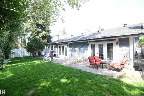 The rear yard is accessed by bright garden doors off of the huge kitchen eating area, and also from an additional set of garden doors in the master suite - 572 Lessard Drive Nw, Edmonton, AB - Outdoor With Deck Patio Veranda