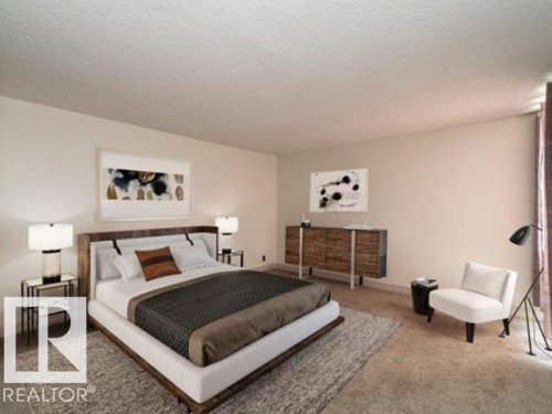 Spacious bedroom featuring light-colored walls and wall-to-wall carpeting - #1203 10025 113 St Nw, Edmonton, AB - Indoor Photo Showing Bedroom