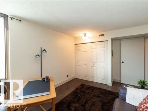 Hardwood-style flooring throughout - #1203 10025 113 St Nw, Edmonton, AB - Indoor Photo Showing Other Room
