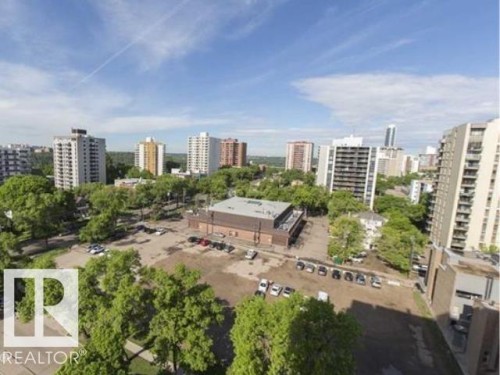 Urban landscape featuring multiple high-rise buildings and abundant mature trees - #1203 10025 113 St Nw, Edmonton, AB - Outdoor With View