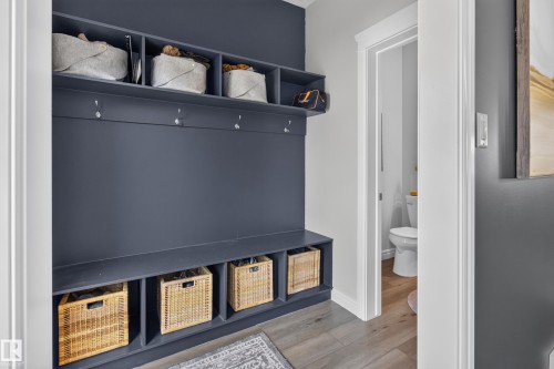 Built-in mudroom storage featuring upper cubbies, coat hooks, and lower storage compartments - 6 Daniel Street, Fort Saskatchewan, AB - Indoor Photo Showing Other Room