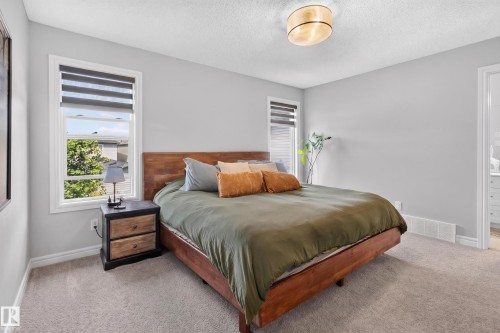 Light gray painted walls complementing neutral carpeting - 6 Daniel Street, Fort Saskatchewan, AB - Indoor Photo Showing Bedroom