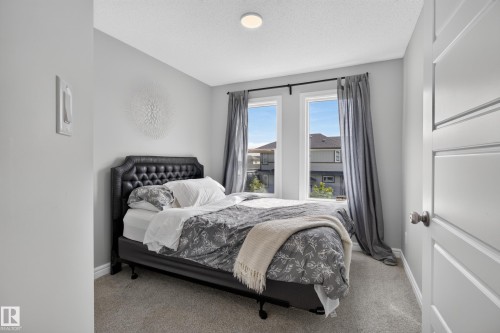 Bedroom featuring light gray walls, textured carpeting, and a white ceiling with recessed lighting - 6 Daniel Street, Fort Saskatchewan, AB - Indoor Photo Showing Bedroom