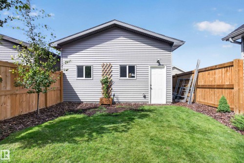 Detached structure featuring light gray horizontal siding, an entry door, and two windows - 6 Daniel Street, Fort Saskatchewan, AB - Outdoor With Exterior