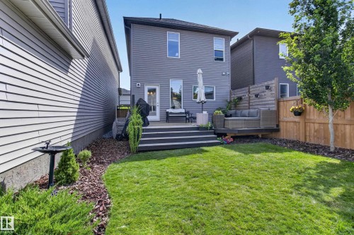 Manicured backyard featuring a multi-level deck, lush green lawn, and a privacy fence - 6 Daniel Street, Fort Saskatchewan, AB - Outdoor With Deck Patio Veranda
