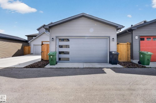 Detached garage featuring light gray horizontal siding and a matching garage door with horizontal frosted window panels - 6 Daniel Street, Fort Saskatchewan, AB - Outdoor With Exterior