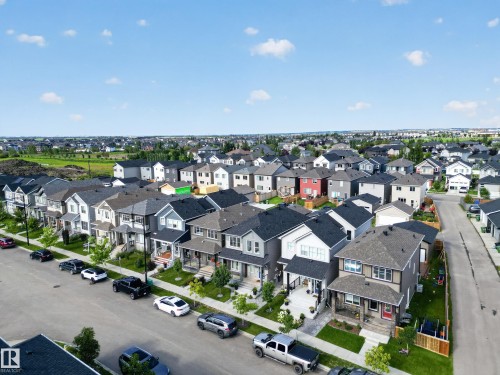 Streetscape featuring a collection of two-story residences with diverse architectural styles, asphalt shingle roofs, and paved streets - 6 Daniel Street, Fort Saskatchewan, AB - Outdoor With View