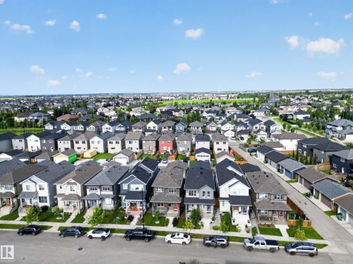 Thriving suburban neighborhood showcasing a collection of contemporary two-story homes with varied architectural styles, black asphalt roofing, and manicured front lawns - 6 Daniel Street, Fort Saskatchewan, AB - Outdoor With View