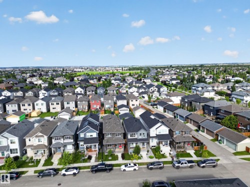 Aerial view showcasing a contemporary streetscape lined with modern residential homes featuring varied architectural styles, pitched rooflines, and dark exterior finishes - 6 Daniel Street, Fort Saskatchewan, AB - Outdoor With View