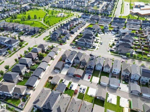 Aerial view of a well-planned residential community featuring tree-lined streets, contemporary single-family homes with modern architectural design, manicured green spaces, and organized street layouts - 6 Daniel Street, Fort Saskatchewan, AB -  With View