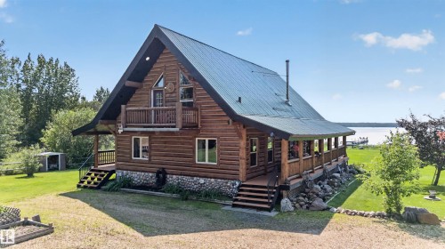 Log home featuring a gabled roof and a wrap-around covered porch - 107 Idlehours Drive, Rural Barrhead County, AB - Outdoor