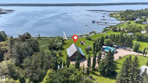 Aerial perspective showcasing a waterfront property with a private dock - 107 Idlehours Drive, Rural Barrhead County, AB - Outdoor With Body Of Water With View