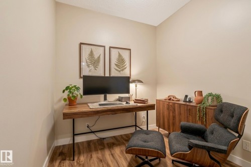 Dedicated room featuring wood-finish flooring, light neutral-toned walls, and white baseboards - #120 8931 156 St Nw, Edmonton, AB - Indoor Photo Showing Office
