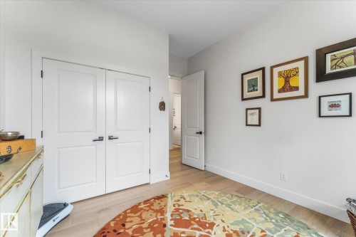 Light-toned wood-finish flooring complements the neutral wall color - #52 Riverstone Close, Rural Sturgeon County, AB - Indoor Photo Showing Other Room