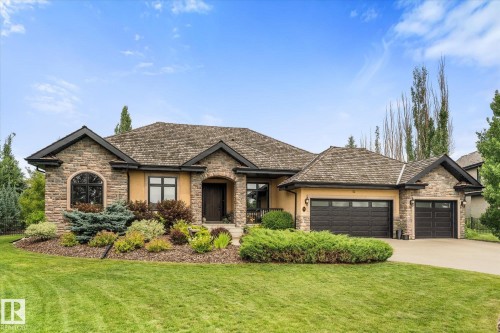 Stone and stucco exterior featuring a multi-gabled roofline and an arched entryway - #52 Riverstone Close, Rural Sturgeon County, AB - Outdoor With Facade
