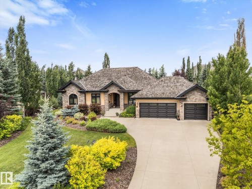 Stone and stucco exterior with a cedar shake roof - #52 Riverstone Close, Rural Sturgeon County, AB - Outdoor With Facade