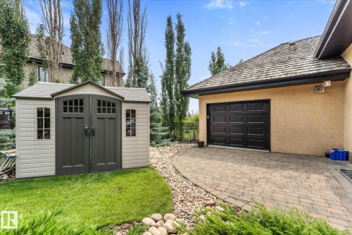 Attached storage shed with paneled double doors and side windows - #52 Riverstone Close, Rural Sturgeon County, AB - Outdoor With Exterior