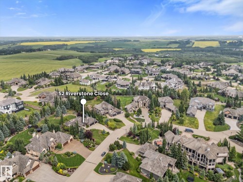 Aerial perspective of a developed residential community with extensive landscaping and mature trees - #52 Riverstone Close, Rural Sturgeon County, AB - Outdoor With View