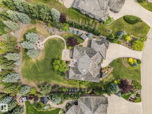 Expansive property featuring a multi-gabled roofline, mature trees, and a manicured lawn - #52 Riverstone Close, Rural Sturgeon County, AB - Outdoor With View
