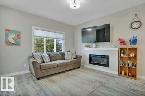 729 Berg Loop, Leduc, AB - Indoor Photo Showing Living Room With Fireplace