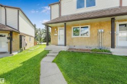 Concrete walkway leading to a covered entry with concrete steps - 