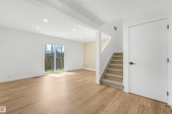 Open-concept living area featuring wood-finish flooring, recessed lighting, and a sliding glass door to the exterior - 