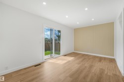 Spacious room featuring wood-finish flooring, recessed lighting, and a neutral color palette - 