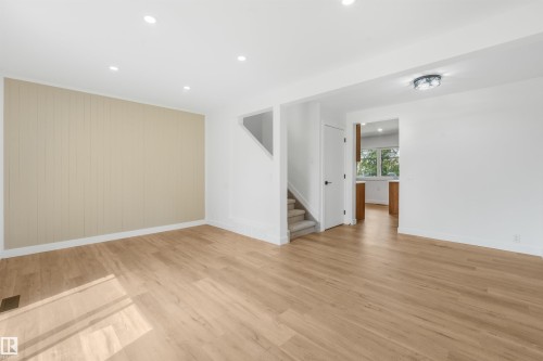 Bright, open living space featuring pristine wood-finish flooring throughout, recessed ceiling lighting, and neutral wall finishes - #39 14511 52 Street Nw, Edmonton, AB - Indoor Photo Showing Other Room